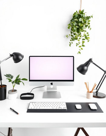 Workplace with computer, keyboard, mouse, lamp and plant.