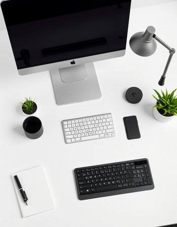 Top view of white office desk with computer, keyboard, mouse, notebook and plant.の写真素材