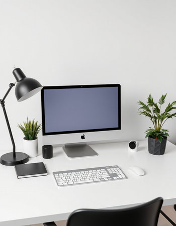 Workplace with computer, keyboard, mouse and plant on white table