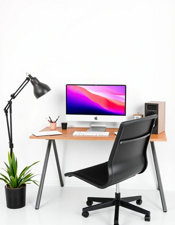Workplace with computer, lamp and plant on a white wall background