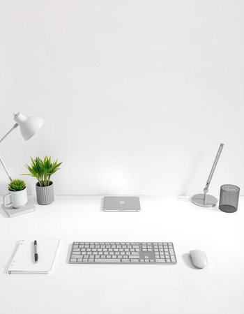 White office desk with computer, mouse, keyboard, lamp and plant
