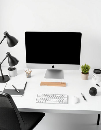 Workplace with computer, keyboard, mouse, coffee cup and stationeryの写真素材