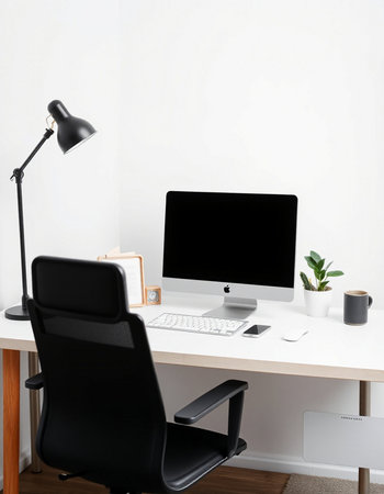Modern workplace with computer, lamp and stationery on table in office