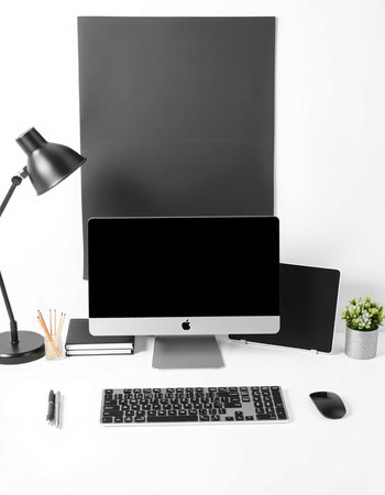 Modern workspace with blank screen computer monitor, coffee cup, stationery and laptop on white backgroundの写真素材