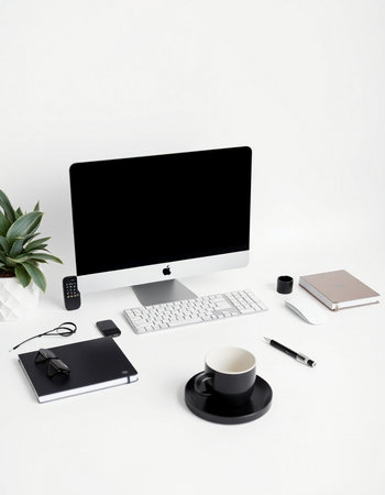 White office desk table with computer, supplies and coffee cup. Top view, flat lay