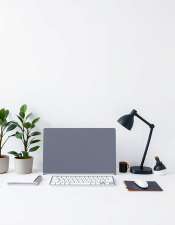 Laptop, coffee cup and plant on white table. Workplace concept