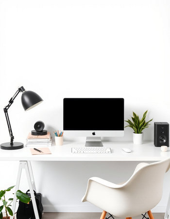 workplace with computer, lamp and stationery on white wall background