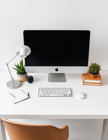 Front view of modern workplace with blank black computer screen, keyboard, stationery and other...