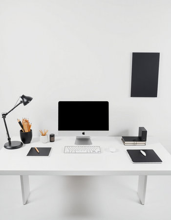workplace with computer, lamp and stationery on white wall background