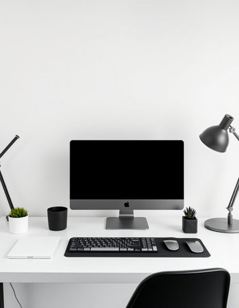 workplace with blank screen computer, keyboard, mouse, notebook, lamp and plant on white wall...