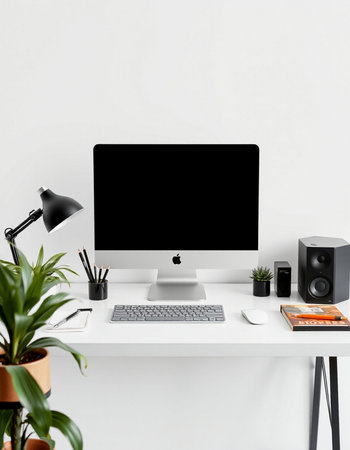 Modern workspace with blank computer screen, office supplies and plants. Mock up