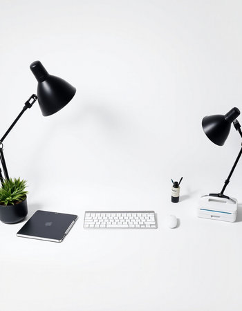 Modern workspace with computer keyboard, mouse, lamp and plant on white backgroundの写真素材