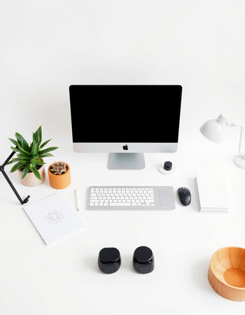 Modern workspace with computer, keyboard, mouse, coffee cup and plant on white background
