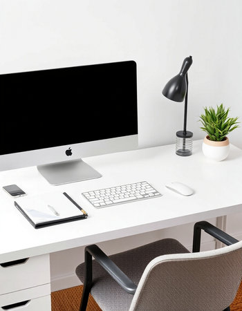 Modern workspace with computer, mobile phone and coffee cup on white table