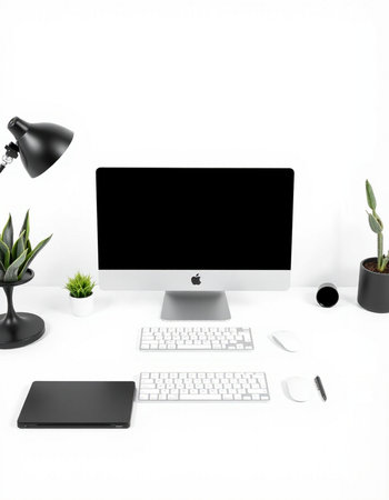 Modern workspace with blank computer monitor, keyboard, mouse, coffee cup and plant.