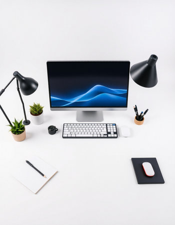 Modern designer desktop with computer, stationery and copy space on white backgroundの写真素材