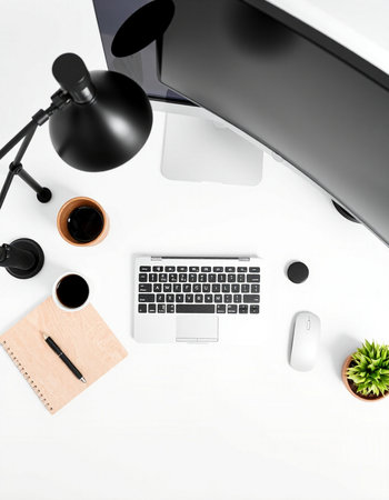 White office desk with computer, supplies and coffee cup. Top view