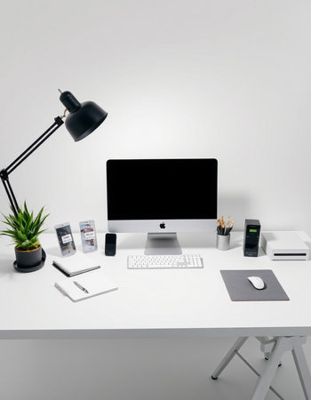 workplace with computer, stationery and lamp on table