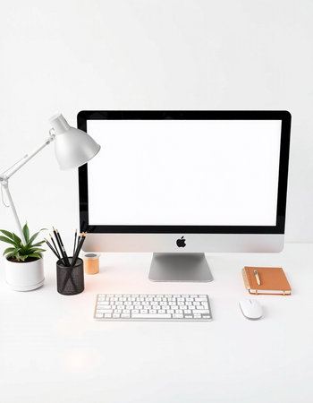 Modern workplace with blank screen computer, keyboard, stationery and coffee cup on white backgroundの写真素材