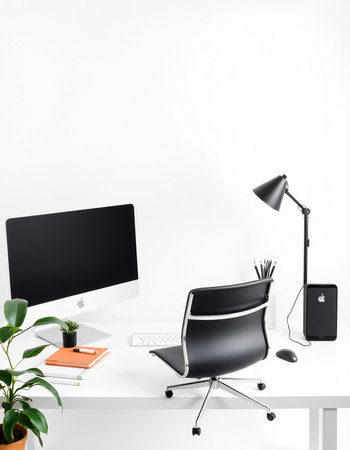 Modern office workplace with computer, stationery and plant on white wall background