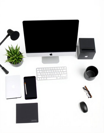 Office desk with computer, keyboard, mouse, mobile phone and accessories