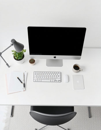 Top view of modern workplace with blank computer screen, supplies and coffee cup. Mock up