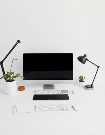 Modern workplace with computer, keyboard, mouse, lamp and plant on white background