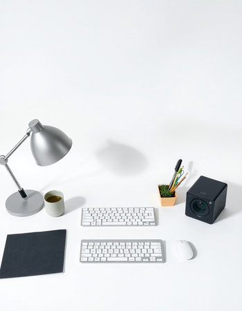 White office desk with computer keyboard, mouse, coffee cup, graphic tablet and stationery