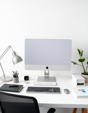 workplace with computer, keyboard, mouse, stationery and plant