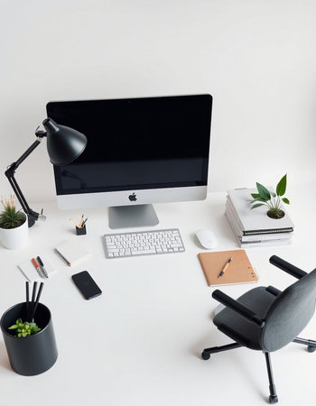 Top view of modern workplace with computer, stationery and plants on white backgroundの写真素材
