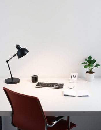 A white table in an office with a lamp and a plantの写真素材
