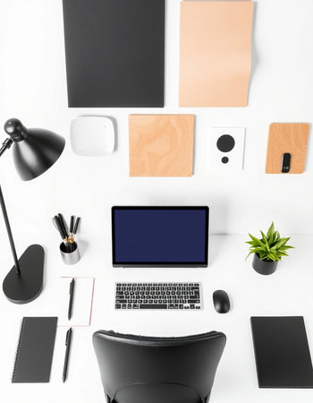 Top view of modern workplace with blank stationery and gadgets on white backgroundの写真素材