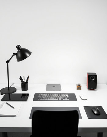 White office desk with computer, mouse, keyboard, lamp and other objectsの写真素材