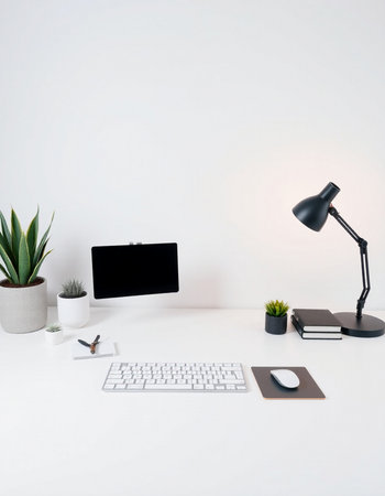 White office desk with computer, plants and other items