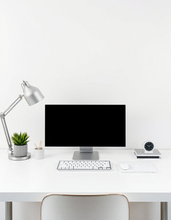Workspace with computer, keyboard, mouse, lamp, coffee cup and other items