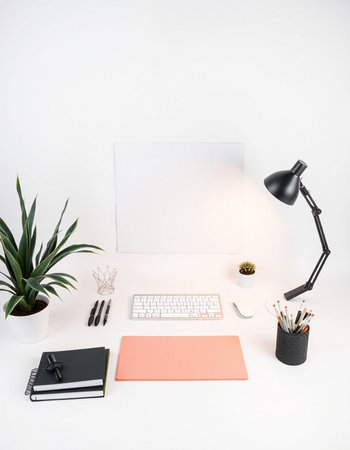 Minimal workspace with computer keyboard, stationery and plant on white background