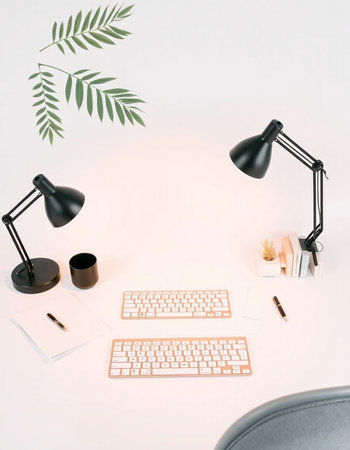 Modern workplace with keyboard, mouse, coffee cup, notebook and stationery on white backgroundの写真素材