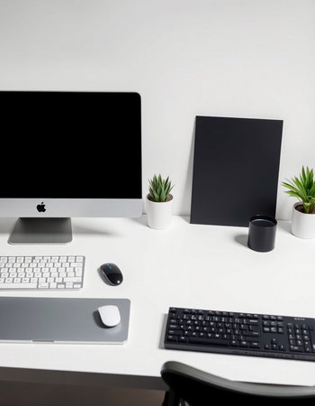 Workplace with computer, mouse, keyboard and plant on white table
