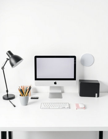 Workplace with modern computer, stationery and lamp on white tableの写真素材