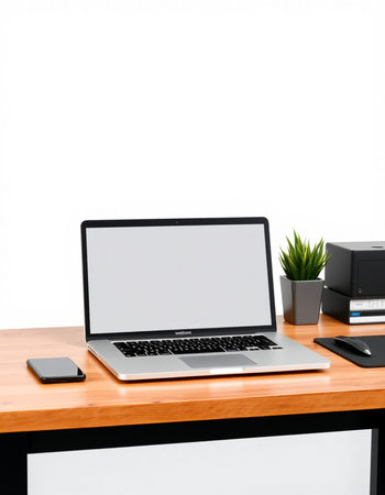 Modern workspace with blank screen laptop computer, mobile phone and office supplies on wooden table