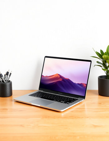 Laptop on wooden table and white wall background.