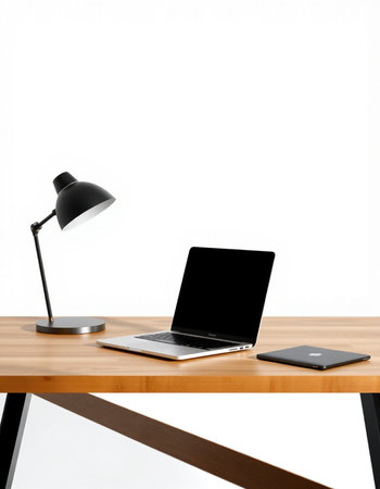 Laptop and smartphone on wooden desk with white wall in the background