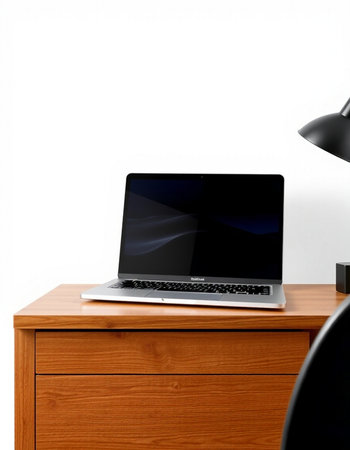 Laptop on a wooden table with a lamp on a white background