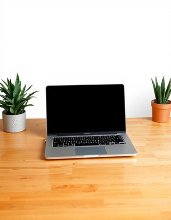 Laptop with blank screen on wooden table and white wall background.の写真素材