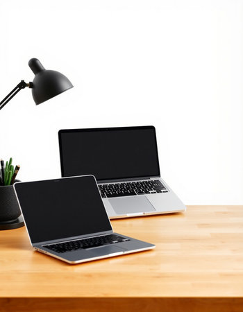 Modern workspace with laptop, tablet and coffee cup on wooden table over white background
