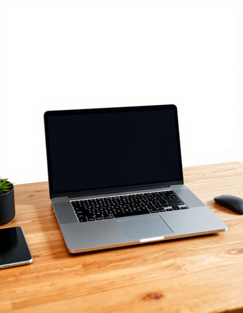 Laptop with black screen on wooden desk isolated on white background.