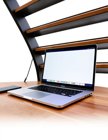 Laptop on the wooden table, isolated on white background. 3d render.