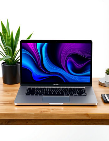 Laptop on wooden table with white wall background.