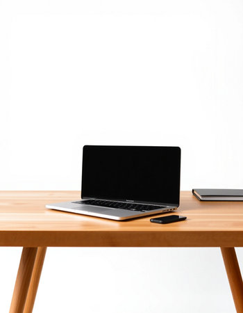 Laptop with blank screen on wooden table isolated on white background.