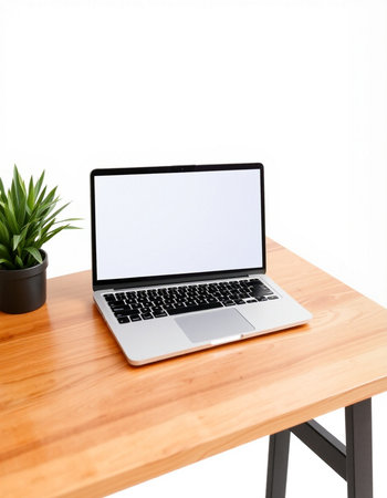 Laptop with blank screen on wooden desk isolated on white background.